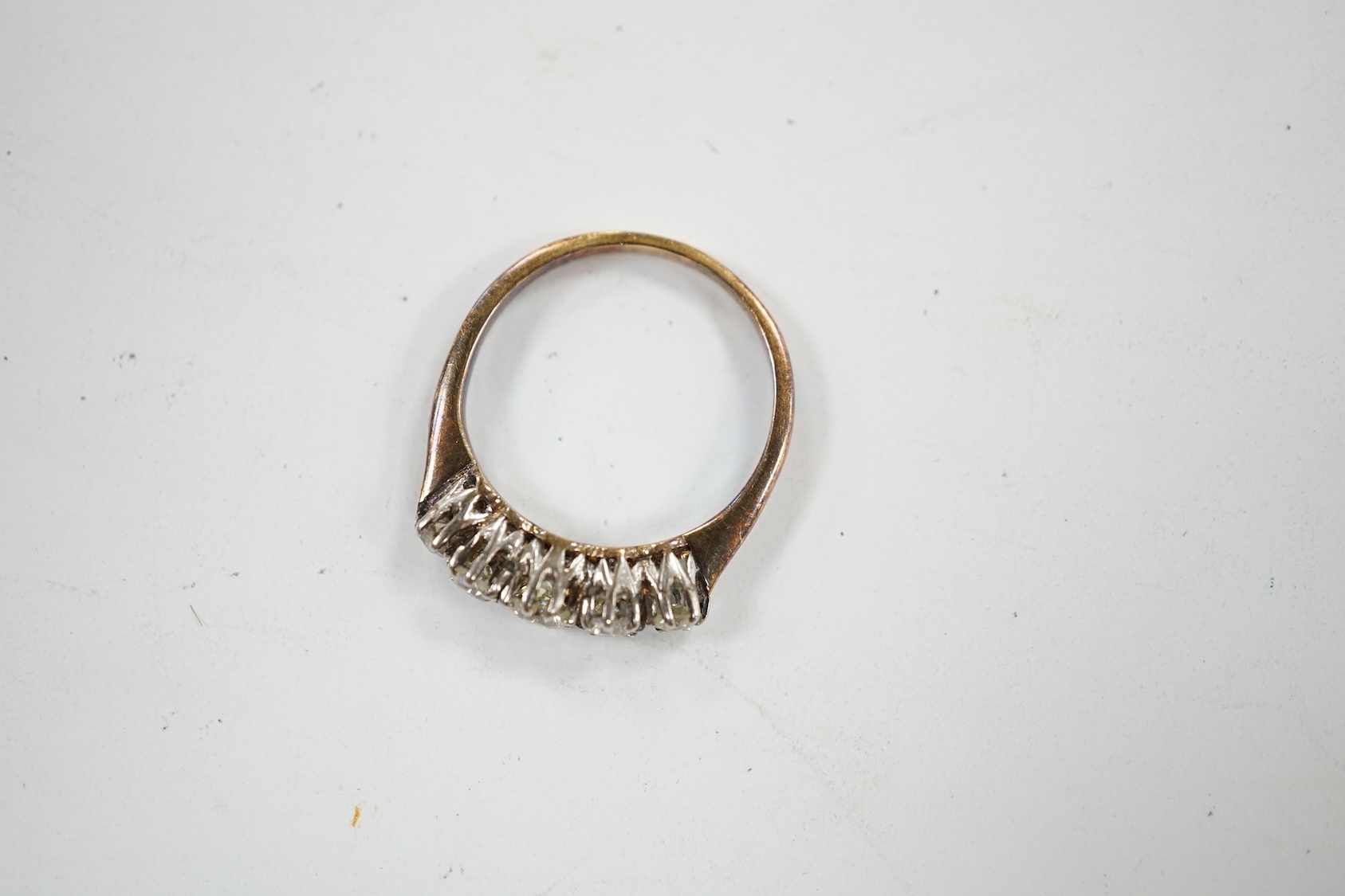 An 18ct and graduated five stone diamond set half hoop ring, size L, gross weight 2.8 grams. Condition - poor to fair